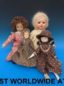 Four dolls of varying sizes and material