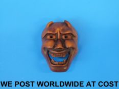 A Japanese boxwood mask netsuke of a dem