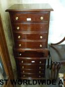 A pair of four-drawer bedside cabinets (