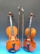 Two cased violins and bows (length of ba
