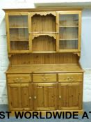 A pine dresser with two glazed cupboards