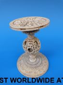 A Chinese ivory stand with carved top an