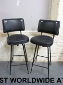 A pair of leather upholstered bar stools