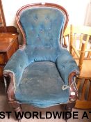 A 19thC spoon back armchair with scrolli