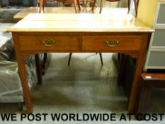 An oak side table or desk fitted two dra