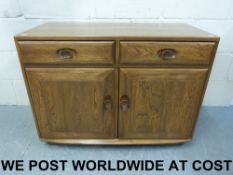 A small Ercol light elm sideboard with t