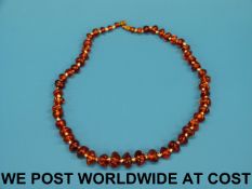 An amber necklace, the beads transparent