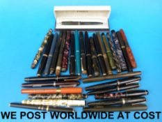 A collection of over 30 pens, many fount