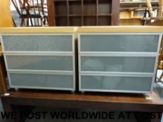 A pair of modern three drawer bedside ca