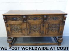 An early 20thC carved oak sideboard (wid