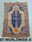 A small orange and navy rug (85cm x 138c
