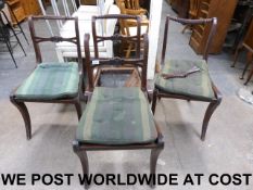 A set of four cane seated Regency dining