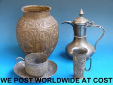 An Indian white metal cup and saucer tog