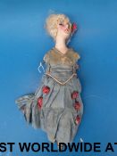 A continental doll with ceramic head and