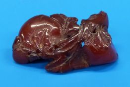 A Chinese amber carving of two peaches,