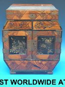 A small Japanese cabinet with lacquer pa