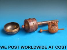 A Tibetan prayer wheel together with a