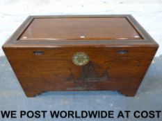 A Chinese camphor wood chest with carved