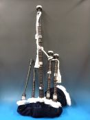 A cased set of rosewood bagpipes with sy
