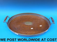 An oak tray with pierced brass gallery,