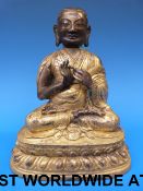 A Tibetan gilt bronze figure of a Lama w