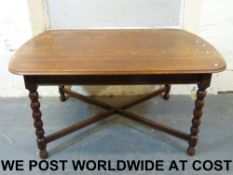 An oak dining table with bobbin turned l