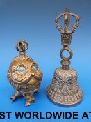 A Tibetan bronze handbell cast on the sh