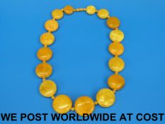 An amber necklace of egg yolk colour, th