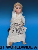 An Armand Marseille doll in period costu