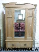 A pine wardrobe with central mirror door