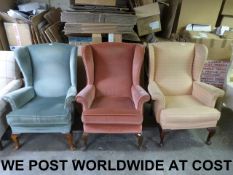 Three variously upholstered wing back ar