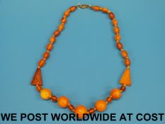 An amber necklace of oval and circular b