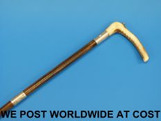 A rhinoceros horn riding crop with a bon