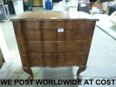 A small serpentine fronted chest of thre