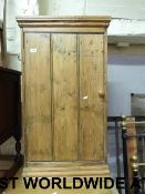 A pine cupboard with three plank door (w