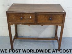 An oak two drawer desk or side table (wi