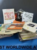 A large collection of sheet music, some