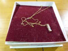 A yellow metal diamond pendant stamped 9