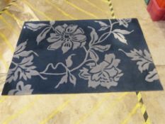 A navy blue floral rug