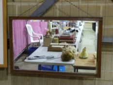 A framed bevelled glass mirror