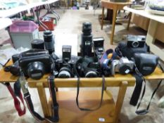 A box of cameras  and accessories includ