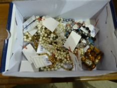 A box of costume jewellery including fau