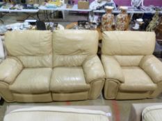 A beige leather two seater sofa and matc