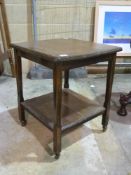 A small square occasional table with she