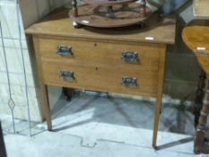 An Art Nouveau oak chest of two drawers