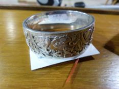 A white metal embossed bangle decorated
