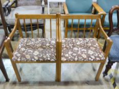 A pair of stick back modern armchairs