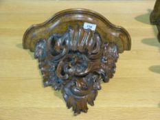 A carved scrolling wall bracket