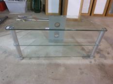 A glass and aluminium three tier TV stan