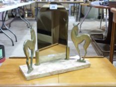 An Art Deco mirror flanked by two deer o